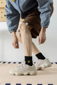 Detailed close-up of men's cotton mid-tube socks featuring a yellow lightning embroidery.