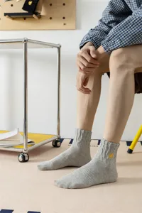 Men's gray cotton crew socks featuring a stylish yellow lightning bolt embroidery detail for daily wear.