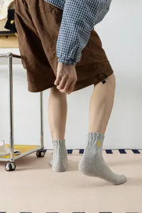 Men's grey ribbed cotton crew socks featuring stylish yellow lightning embroidery detail daily wear.