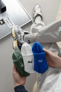 Men's stylish mid-tube casual cotton socks with embroidered letter details for daily sports wear.