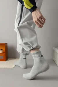 Grey ankle socks detail shot featuring side embroidered letters and comfortable cotton knit fabric.