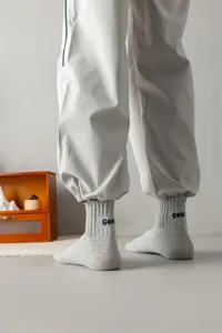 Men grey mid-calf combed cotton socks with heel embroidery, ideal for casual and sports wear.