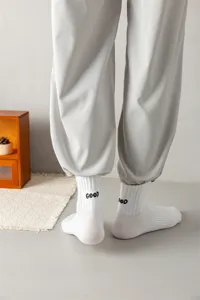 Men's white crew socks with embroidered 'GOOD' letter on heel, casual combed cotton sport socks.