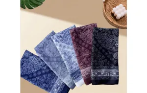 Close-up details of vintage paisley print square scarves, showing delicate border patterns.