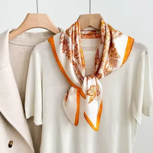 Detail view of the luxury silk square scarf featuring elegant vintage floral and butterfly print.