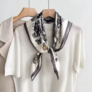 Luxury style silk square scarf with elegant butterfly and botanical print for women.