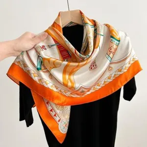Silk square scarf detail view, elegant orange and strap pattern for spring outfit.