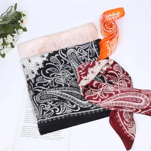 Elegant paisley printed square silk scarf detail, lightweight fashion headscarf accessory.
