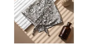 Vintage black and white paisley print triangular scarf with delicate beaded tassel details.