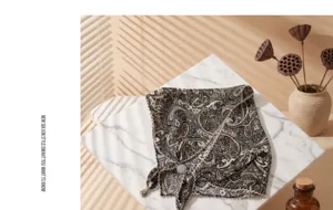 Retro paisley triangular scarf with beaded edge and breathable fabric for summer vacation.