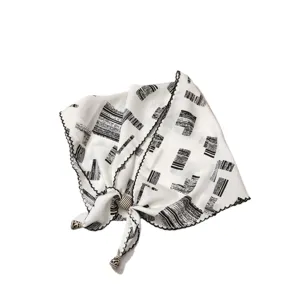 Retro black and white abstract print triangular scarf with beaded tassel and scalloped lace edge.