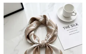 Elegant beige floral silk twill square scarf for women, classic design detail shot.