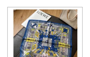 Silk scarf detail showcasing intricate blue and yellow architectural print, elegant accessory.