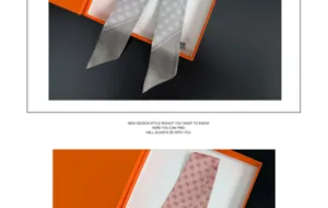 Detail view of the elegant slender silk scarf with lovely heart patterns in gift box.
