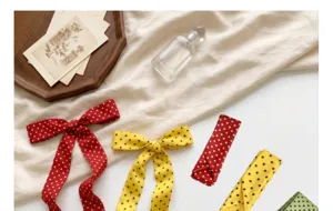 Detail view of polka dot long silk scarf, bow headband, stylish hair accessory for women.