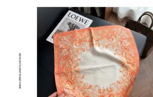 Close-up detail of the elegant baroque floral orange square scarf showcasing intricate design.