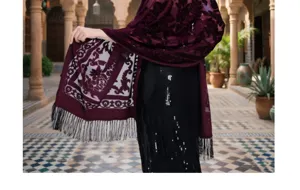 Detailed view of the elegant maroon velvet shawl featuring floral patterns and fringe.