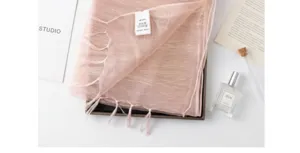 Silk blend long scarf with elegant tassels, soft and versatile fashion accessory for women.