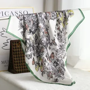 Silk square scarf featuring intricate floral and butterfly prints with green hem details.