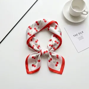 Chic women square silk scarf with elegant red cherry print, versatile fashion accessory.