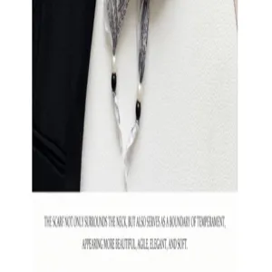 Close-up detail of vintage floral narrow silk scarf with pearl and bead decoration, elegant style.