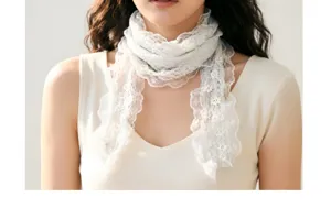 White lace scarf detail showing delicate floral trim and pleated ribbon design for women.