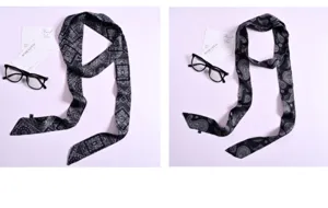 Primo piano dettagliato della sciarpa in seta stampata in bianco e nero con paisley.