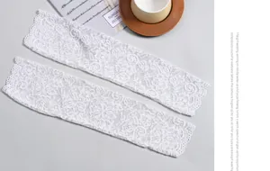 Detail shot of white lace ice silk sun protection sleeves, breathable arm cover for summer.