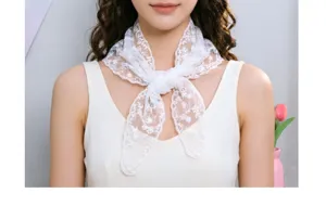 White lace triangle scarf detail shot, elegant neckerchief accessory for women's stylish wear.