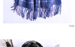 Detail view of the soft imitation cashmere plaid scarf featuring fine fringes and texture.