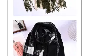 Detailed view of the black and white classic plaid imitation cashmere scarf with soft fringes.