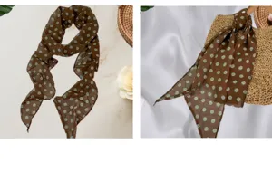 Vue détaillée du foulard long en mousseline marron à pois, noué élégamment comme accessoire.
