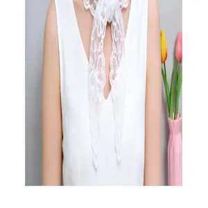 Close up view of white floral lace triangle scarf detail, elegant decorative neck tie accessory.