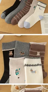 Cute cartoon animal embroidered detail shot of Korean style college cotton mid-tube socks with ruffles.
