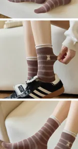 Detailed view of brown striped mid-calf socks featuring cute bear embroidery and knit texture.