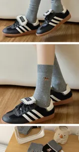 Detail view of cute embroidered dog grey cotton socks with dotted pattern for women.