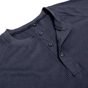 Close-up detail shot of the navy blue waffle knit henley shirt collar and button placket.