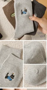 Detailed view of women cotton socks featuring cute cartoon cat embroidery and cozy vertical stripes.