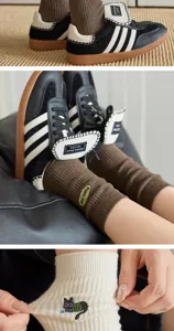 Knit cotton socks detail showing cute cat embroidery and ribbed texture with sneakers.