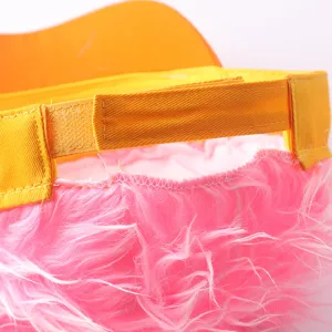 Close-up detail of adjustable yellow strap and pink fuzzy wig baseball cap back.