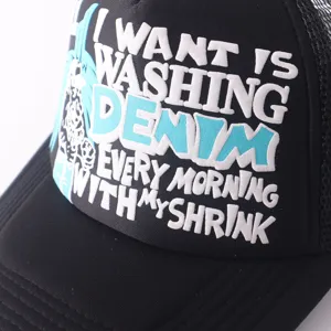 Close-up detail of black trucker hat with 3D white embroidered English slogan lettering.