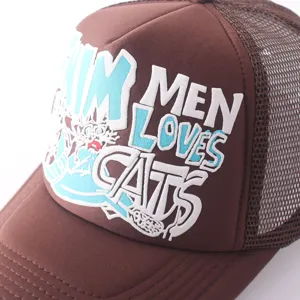 Brown mesh trucker cap detail, featuring bold front lettering graphic and breathable back panels.