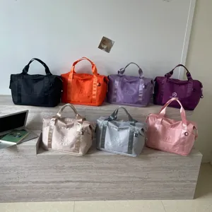 Detailed view of women travel duffel bag variant colors displayed on shelf for fitness gym.