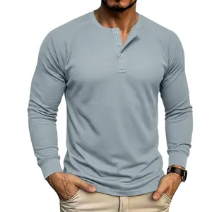 Men's long sleeve waffle knit Henley shirt in light grey with three button placket detail.