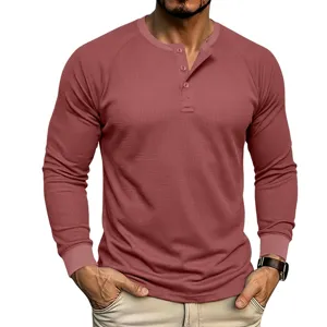 Detail shot of men's long-sleeve waffle knit Henley shirt featuring a classic 3-button placket.