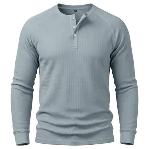 Detail view of men's waffle knit long sleeve henley shirt with button placket texture.