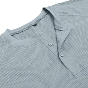 Close-up detail of mens waffle knit Henley shirt collar and three button placket design.