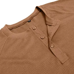 Detail view of men's brown waffle knit long sleeve Henley shirt collar and button placket