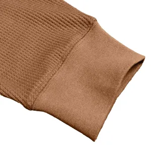 Men long sleeve henley shirt fabric detail closeup, brown waffle knit texture cuff.