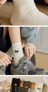 Ribbed cotton women socks featuring cute cat embroidery, comfortable mid-tube design, detail view.